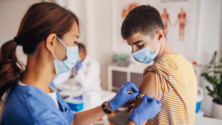 Nurse putting a bandage on a young person