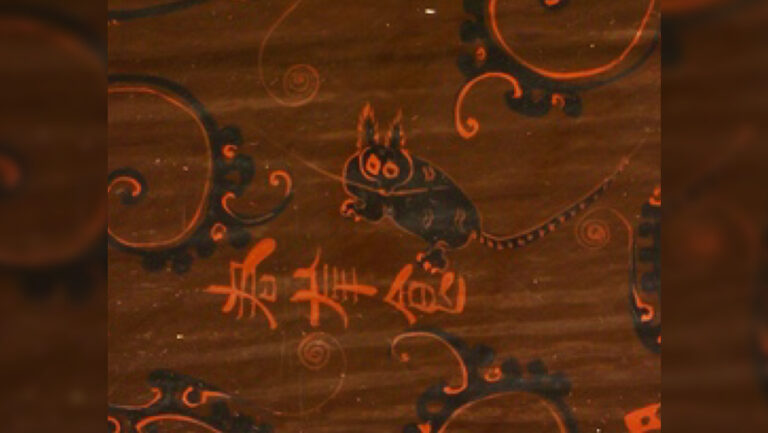 Ancient DNA reveals China’s first ‘pet’ cat wasn’t the house cat A closeup of a bowl found in an ancient tomb includes a depiction of a cat with tall fluffy ears, claws visible, some spots in its black back and a striped tail, reminiscient of a leapard cat.